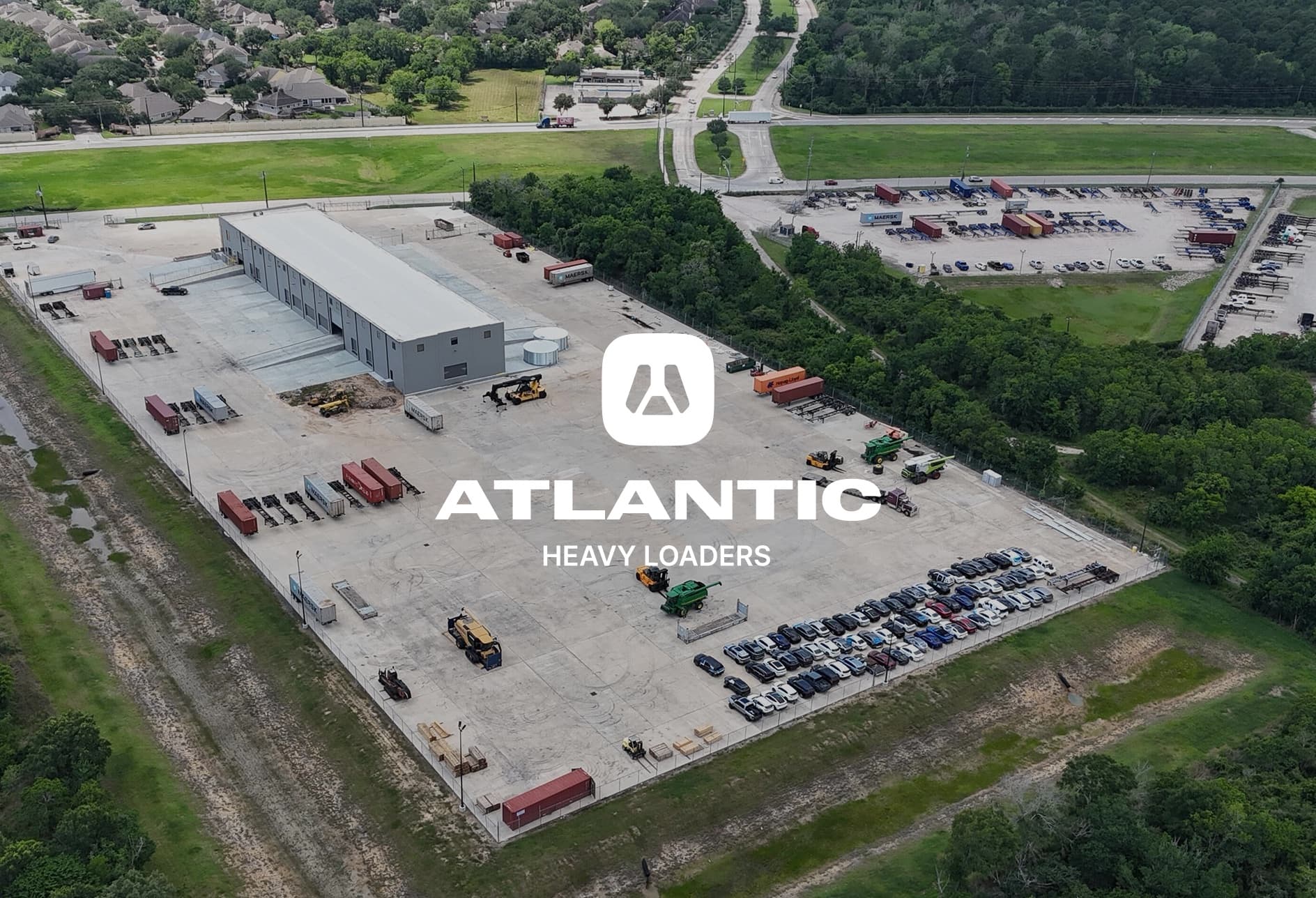Aerial view of the Atlantic Heavy Loaders yard, warehouse, and staged equipment