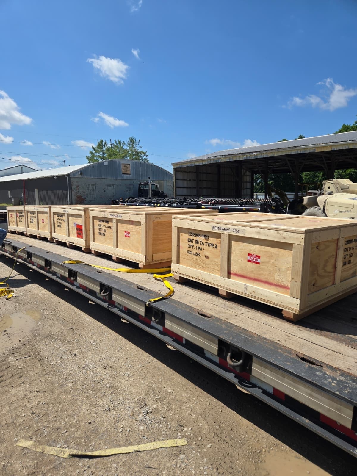 Crated track assemblies staged on the flatbed, ready for pickup