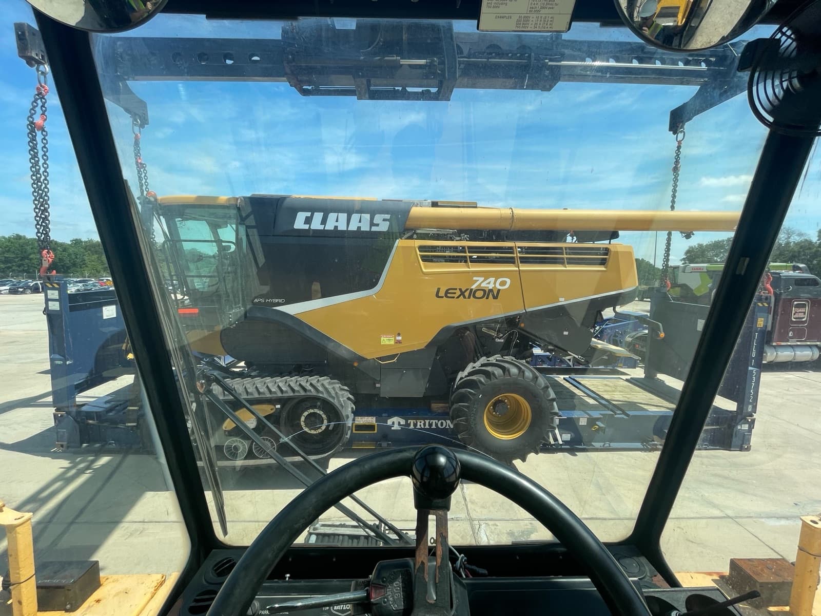 The harvester lined up through the reach stacker operator's windshield