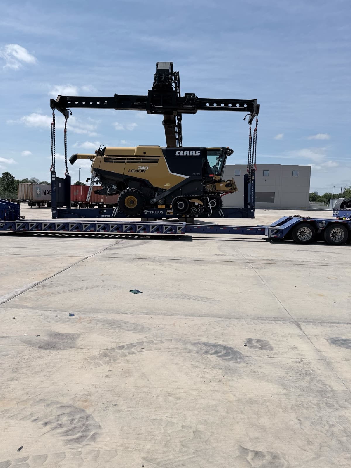 Harvester swung into position over the flat-rack container