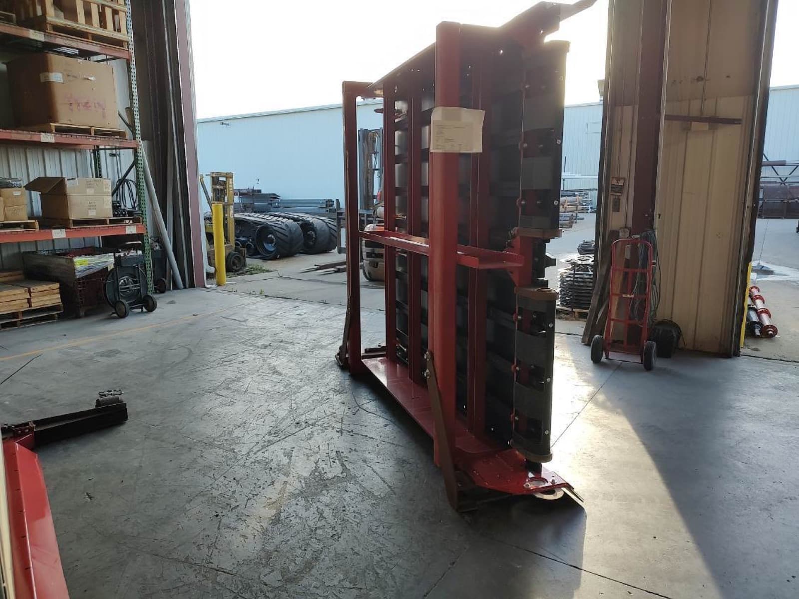 Panel stack braced inside its steel carrying frame at the bay door