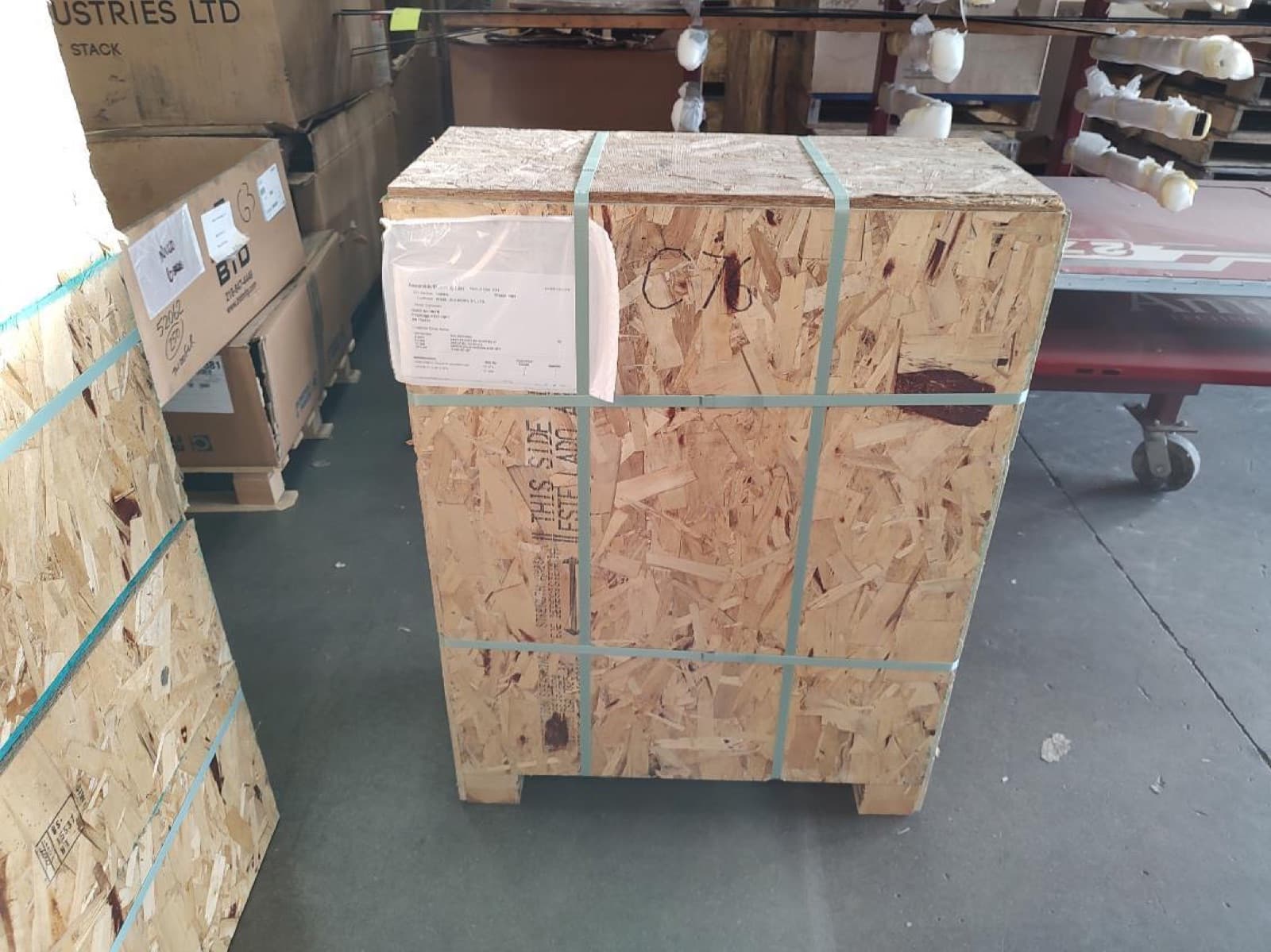 Custom plywood crate built, strapped, and labeled for the smaller components