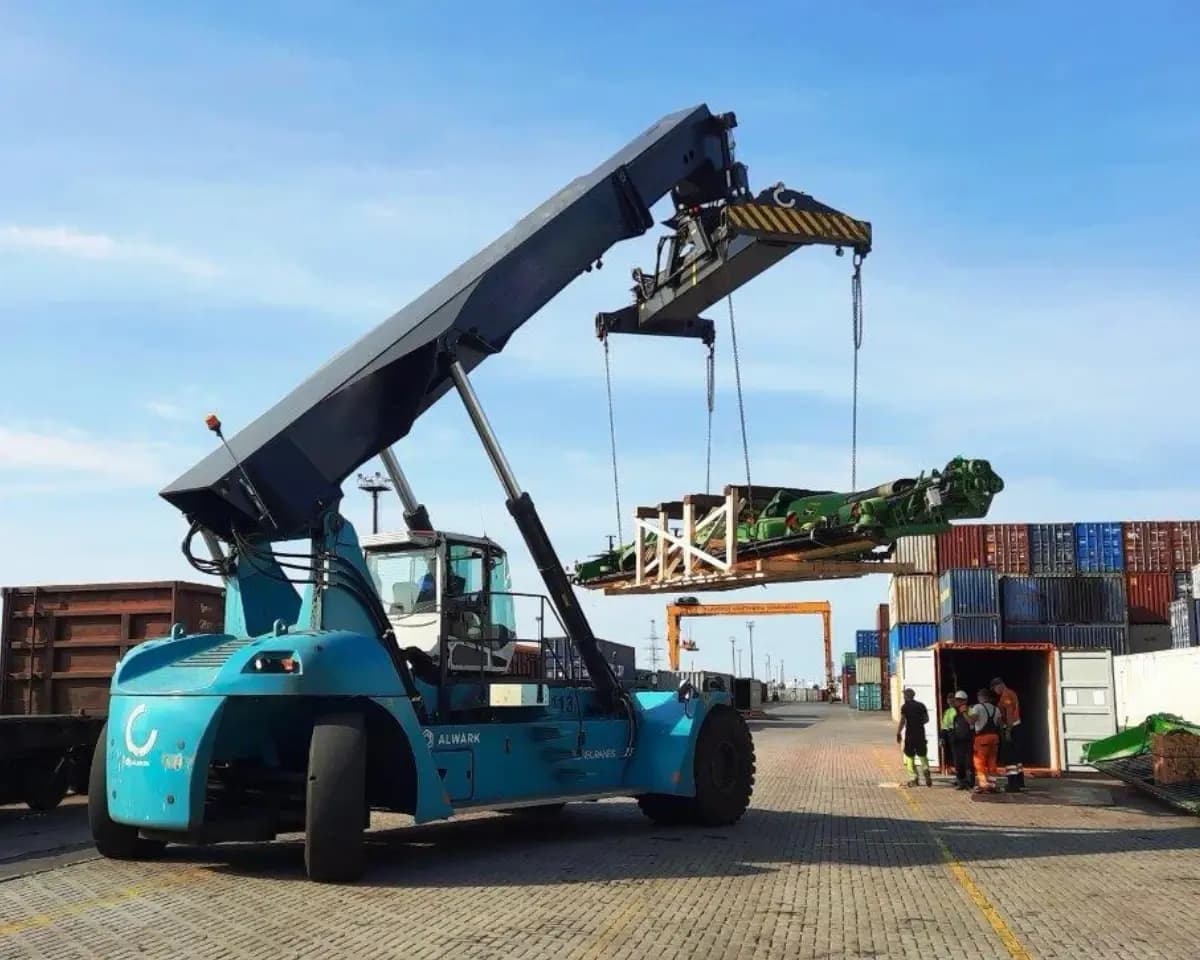 A reach stacker lifting a crated load at the container terminal.