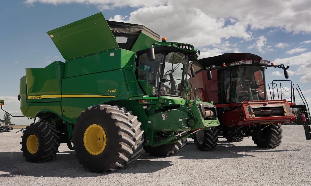 Two combine harvesters parked side by side before cleaning.