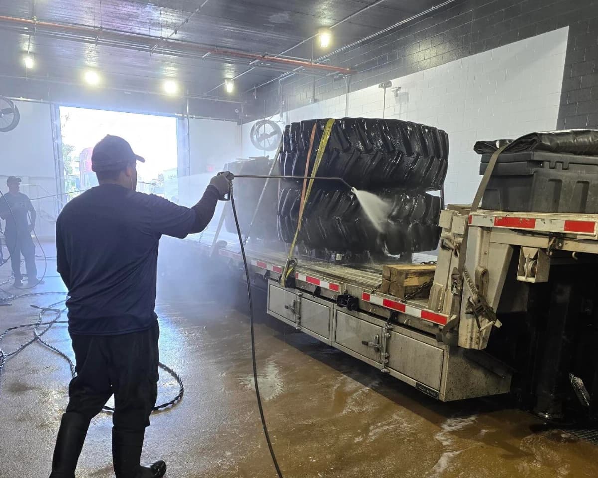 Heavy equipment pressure washed before export.
