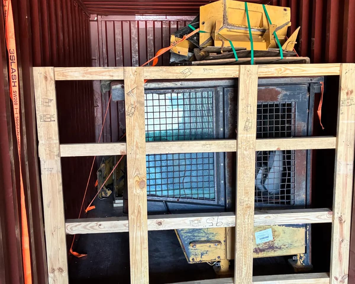 Cab removed from heavy equipment during dismantling for transport.