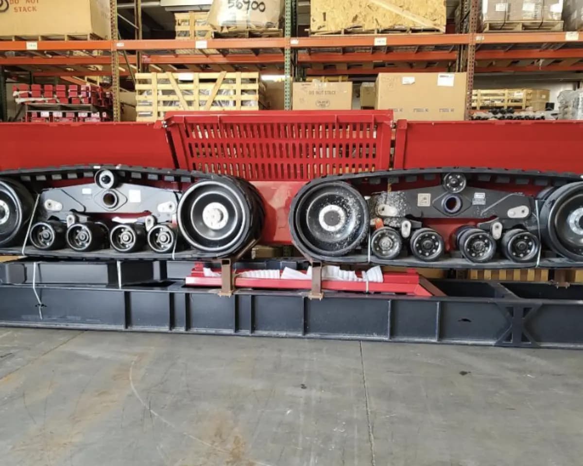 Track assemblies removed from a machine and staged on the warehouse floor.