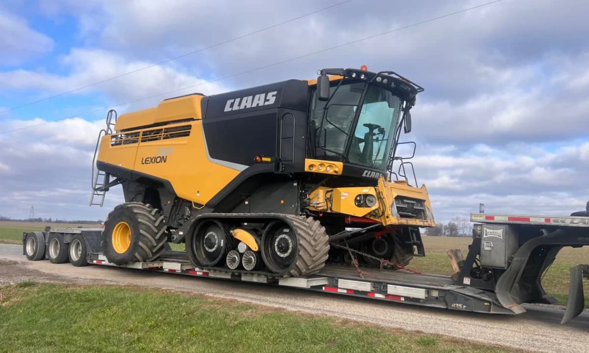 A tracked harvester standing in the yard.