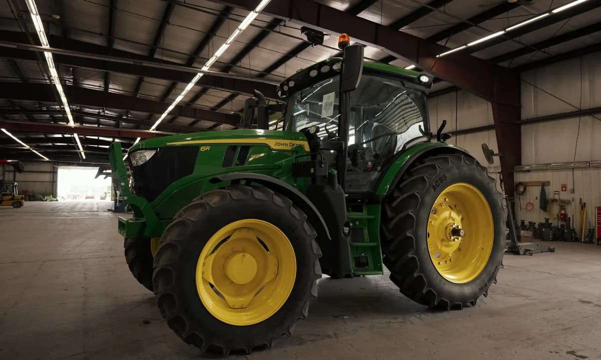 A tractor parked under cover in the warehouse.