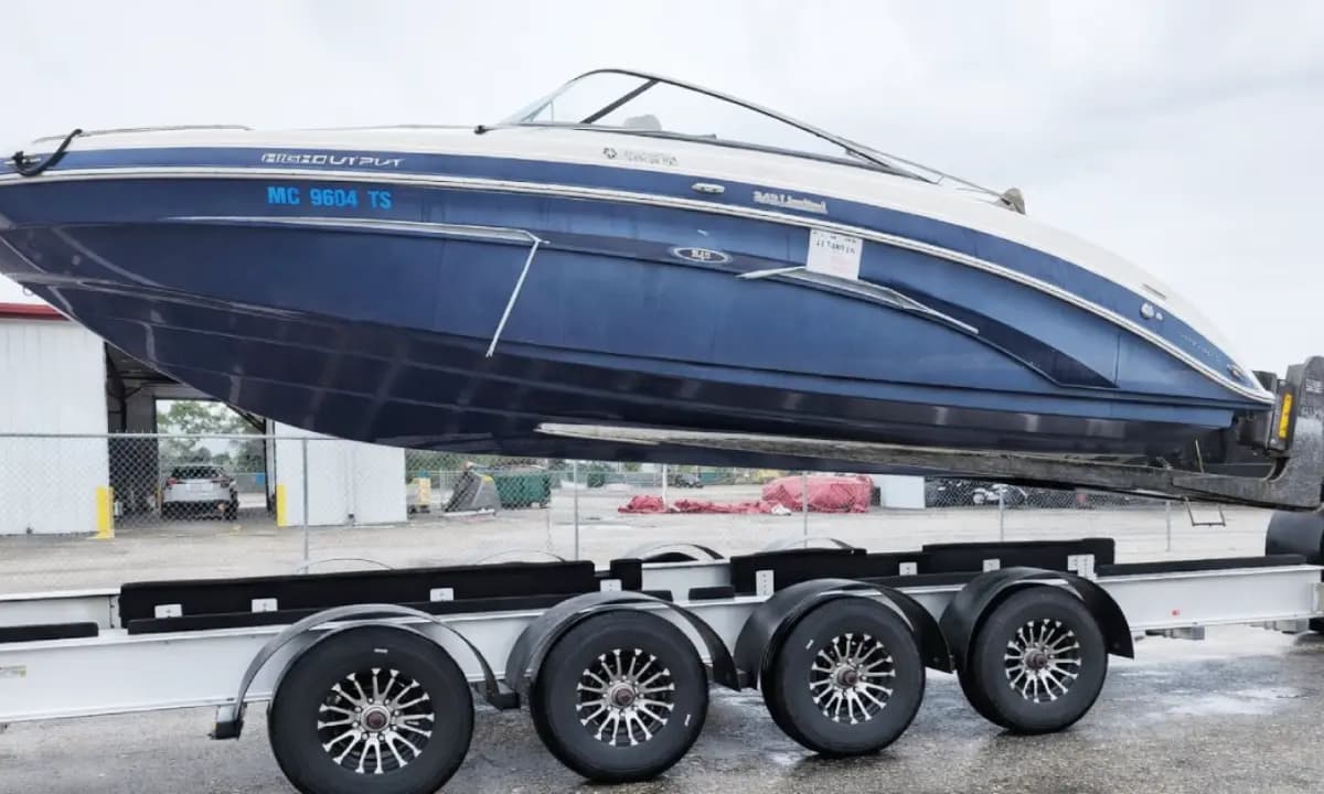 A bowrider carried on a multi-axle trailer.